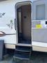 A 2014 Launch 24RLS travel trailer showing an entrance with three steps leading up to an open door
