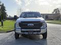 A 2020 Ford F-550 pickup truck facing forward with a shiny chrome grille and large tires visible in the foreground