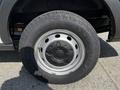 A close-up view of a 2022 Ford Transit wheel showing a silver rim and all-terrain tire with deep treads