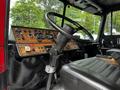 Interior of a 1991 Sutphen Deluge fire truck showcasing the steering wheel and a panel with various gauges and controls