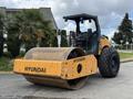 A 2020 Hyundai HR110C double drum roller with a yellow and black color scheme and large rubber tires positioned in a construction setting