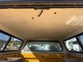 Interior view of a 2013 Chevrolet Silverado 1500 truck bed with a canopy showing the ceiling and rear windows