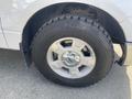 A close-up view of the wheel and tire of a 2012 Ford F-150 showing the alloy rim and rugged tread pattern of the tire