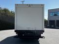 A white 2007 GMC W3500 box truck viewed from the rear with no visible markings or features on the back except for tail lights and a hitch