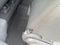 Close-up of a fabric car seat in a 2007 Chrysler PT Cruiser showing the seat adjustment lever and stitching detail