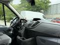 Interior view of a 2017 Ford Transit van showcasing the dashboard and front seating area with controls and displays