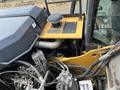 Close-up view of the engine compartment of a 2018 John Deere 350 showing mechanical components and a control panel