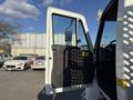 A 2017 International 4300 truck with the driver's side door open and a view of the interior door panel