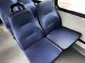Two blue fabric seats arranged side by side in a vehicle interior, featuring a textured surface and ergonomic design.