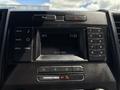 Dashboard of a 2016 Ford F-150 featuring a digital display with temperature and time along with various control buttons and a keypad