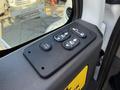 A control panel featuring four buttons including door controls and a winch lock on the inside of a 2017 International 4300 vehicle