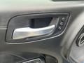 Close-up of the interior door handle of a 2022 Dodge Charger featuring a silver handle and buttons for seat adjustment