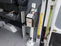 A 2023 Ford Transit interior with a mounted hydraulic lift system featuring a control panel and safety warning label