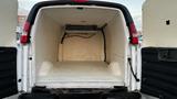 The interior of a 2005 Chevrolet Express van with a spacious cargo area and a ceiling-mounted refrigeration unit