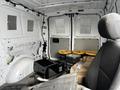 Interior of a 2018 Mercedes-Benz Metris van showing a cargo area with barrels boxes and an empty driver's seat