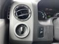 Close-up of the control panel in a 2016 Ford Econoline featuring air vent, headlight switch, and other function buttons