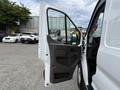 A 2022 Ford Transit with the driver's side door open showcasing the interior and control panel