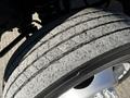 Close-up of a worn tire on a 2008 Ford F-450 SD showing significant tread wear and cracks on the surface