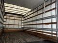 Interior of a 2018 Hino 195 truck with wooden slats along the walls and a flat wooden floor