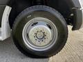 A close-up of a wheel and tire from a 2018 Ford F-550 showing metallic rim and black rubber tread