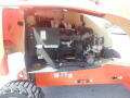 A 2008 JLG Boom Lift with the engine compartment open showing the engine and various mechanical components inside