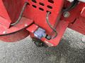 Close-up of a hydraulic control valve on a red 2014 John Deere 1585 Terrain Cut lawn mower with visible wiring and attachment points
