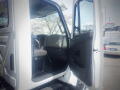 Interior view of a 2016 International WorkStar 7500 truck showing the driver's door open with the driver's seat and dashboard visible