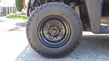 Close-up of a black tire on a 2016 Polaris Ranger 570 Crew showcasing the tread and wheel design