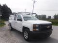 A white 2015 Chevrolet Silverado 1500 pickup truck with a truck bed cap and a roof rack parked on a gravel road