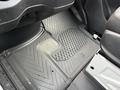A black rubber floor mat with a diamond pattern inside a 2019 Mercedes-Benz Sprinter van cabin
