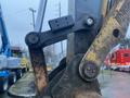 Close-up of a 2014 John Deere 350G excavator arm joint with visible wear and dirt on the metal components