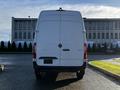 A white 2021 Mercedes-Benz Sprinter van viewed from the rear with a smooth design and the Mercedes emblem visible on the back door