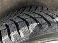 Close-up of a heavily treaded tire on a 2016 Ford Transit Connect showcasing deep grooves and a rugged pattern for traction