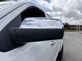 Chrome side mirror of a 2017 Chevrolet Silverado 1500 reflecting cloudy sky