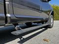 A 2022 RAM 3500 pickup truck showing the side step and part of the truck body in a close-up view