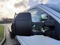 A 2020 Ford F-550 truck featuring a prominent side mirror and a white exterior