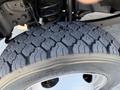 Close-up of a rugged tire with a deep tread pattern mounted on a 2018 Ford F-550 showcasing its durable construction and traction features