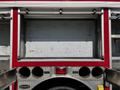 A 2006 Emergency One Fire Truck with several open compartments revealing empty storage areas and visible metal surfaces
