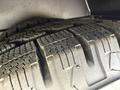 Close-up of a tire from a 2020 Chevrolet Express showing tread patterns with dirt and wear visible on the rubber surface