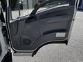 The image shows the open door of a 2007 GMC W3500 displaying the interior door panel and handle with a gray finish