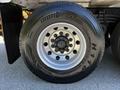 Close-up of a 2005 Volvo VND 122 tire featuring a metallic wheel with multiple bolts and the brand name IronFist prominently displayed on the tire sidewall