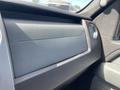 The image shows the interior of a 2012 Ford F-150 featuring a textured dashboard with controls and a circular air vent