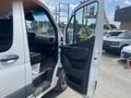 A 2022 Mercedes-Benz Sprinter van with the driver's door opened showing the interior and seating area