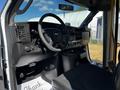 Interior view of a 2019 Chevrolet Express with a steering wheel dashboard controls and black seating