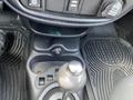 The interior console of a 2005 Chrysler PT Cruiser featuring gear shift lever and controls for power outlet and other functions