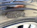 Close-up of a tire with a tread pattern and markings including the numbers 11 and a snowflake symbol