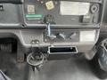 The interior dashboard of a 2007 Freightliner B2 featuring controls for lift deployment and an anti-lock brake indicator with space for a cup holder