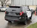 A 2019 Ford Explorer in black and white with a sleek design and black wheels parked in an outdoor setting