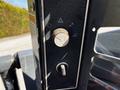Close-up of control panel for a 2017 Gehl R105 featuring various knobs and switches for machine operation