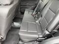The image shows the back seat area of a 2019 Ford Explorer featuring black leather upholstery and three seating positions with seatbelts